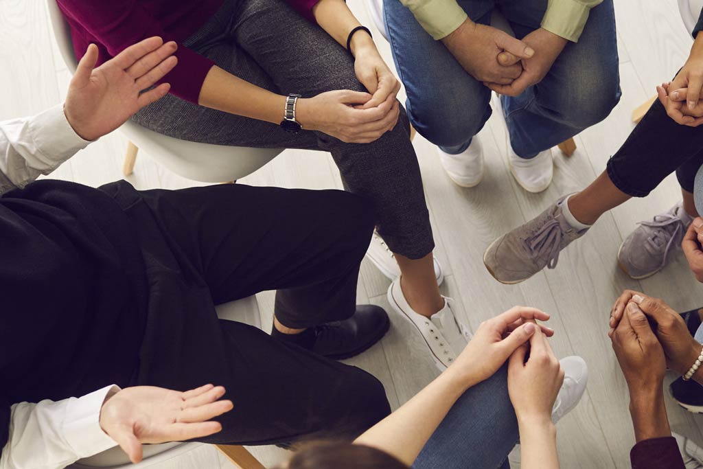 Group of people sitting in a circle.