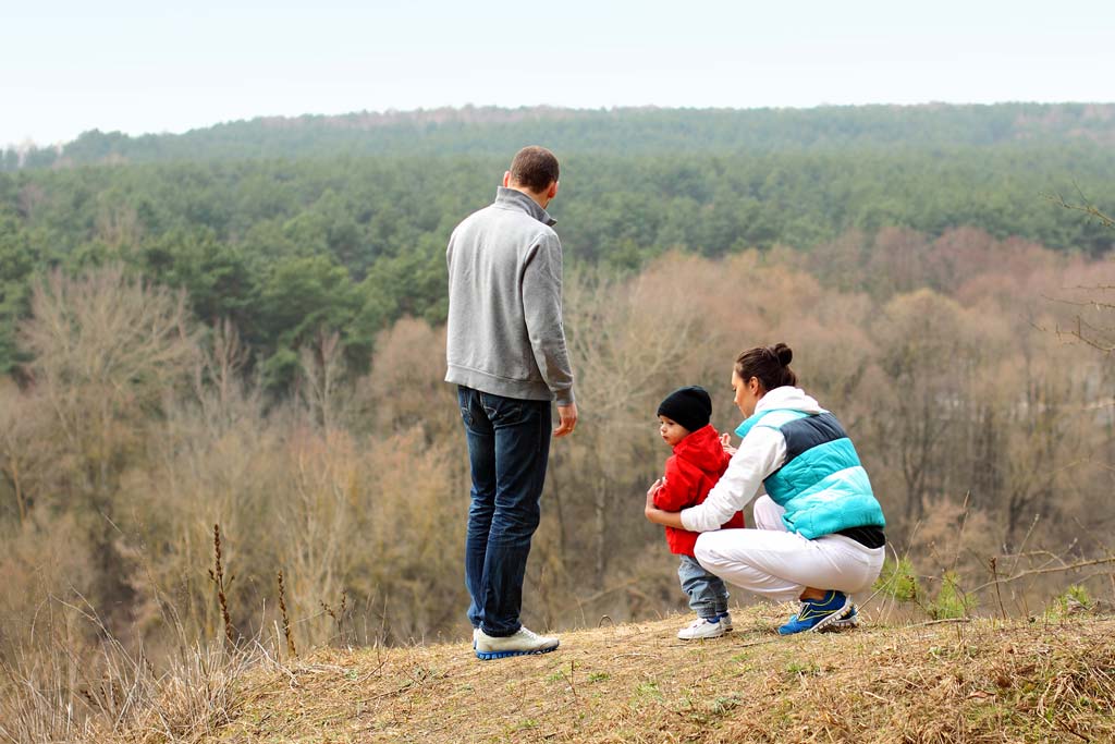 Parents and small child out on a hike.